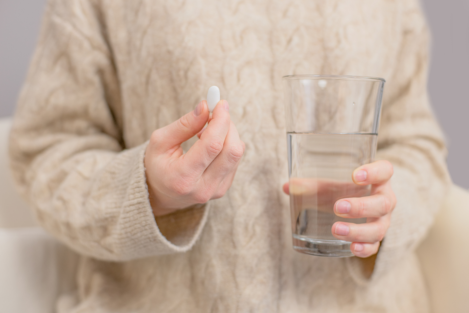 Woman Is Holding abortion Pill And Glass Of Water In Her Hand